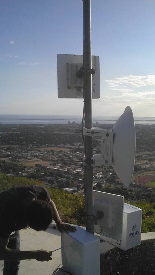 Xtrinet technician servicing hillside wireless equipment